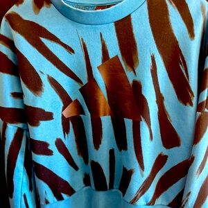 Size medium Adidas sweatshirt blue with black pattern.